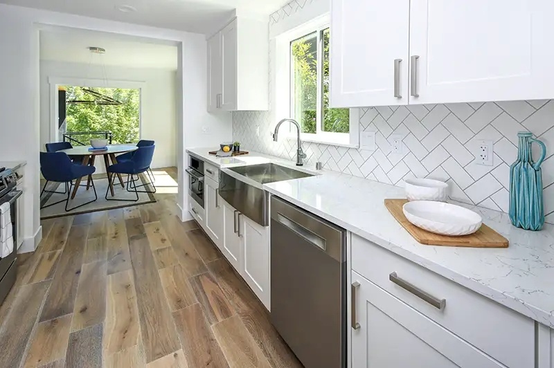 Fresno, CA galley kitchen addition with herringbone backsplash by Imagine Remodeling