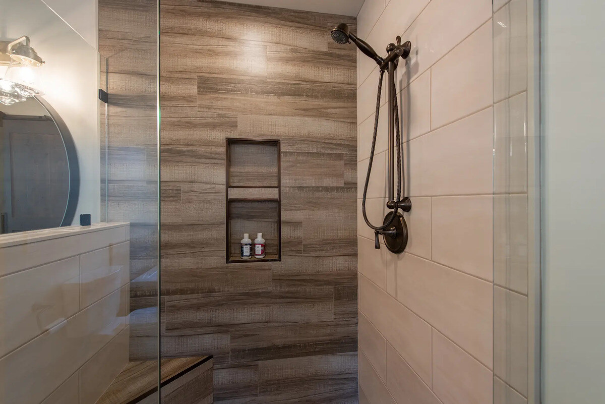 Walk-in shower with built-in shelf and bench in Fresno, CA bathroom by Imagine Remodeling